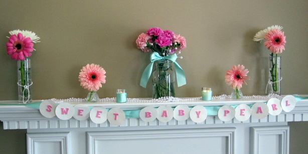 Pretty Pearl Baby Shower Ideas! Pearls in mason jars to hold silverware | OHMY-CREATIVE.COM | Baby Shower Themes | Mason Jars | Centerpiece | Pearls | String of Pearls | Pink and Teal Shower | mantel | mantel garland