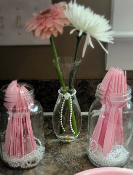 Pretty Pearl Baby Shower Ideas! Pearls in mason jars to hold silverware | OHMY-CREATIVE.COM | Baby Shower Themes | Mason Jars | Centerpiece | Pearls | String of Pearls | Pink and Teal Shower | Gerbera Daisy