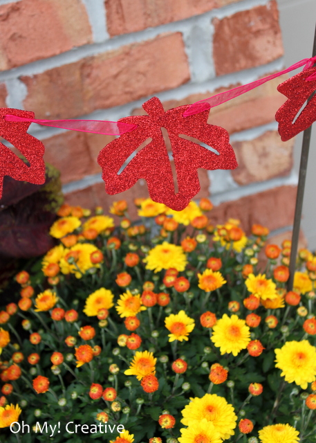 Add a pretty leaf garland to pots of mums for fall!