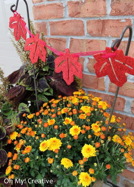 Add a pretty leaf garland to pots of mums for fall!