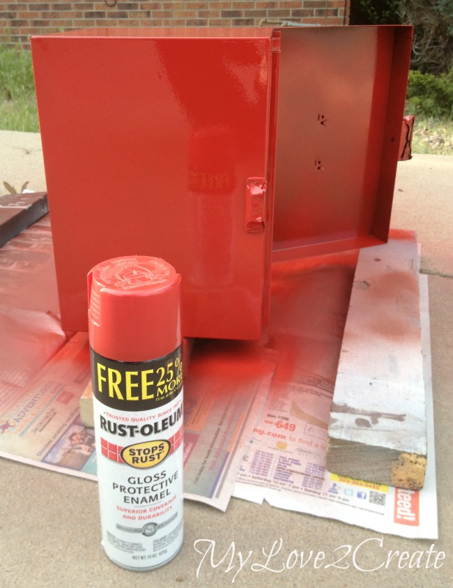 Spray painting metal box red