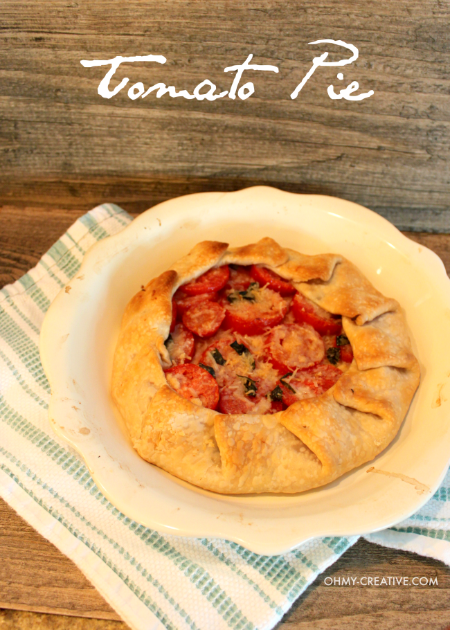 This tastes amazing! Using tomatos from the garden make this lightened up version Tomato Pie Recipe | OHMY-CREATIVE.COM