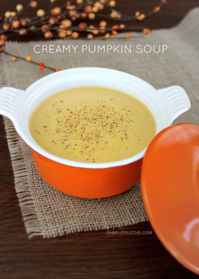 A small orange bowl of creamy pumpkin soup
