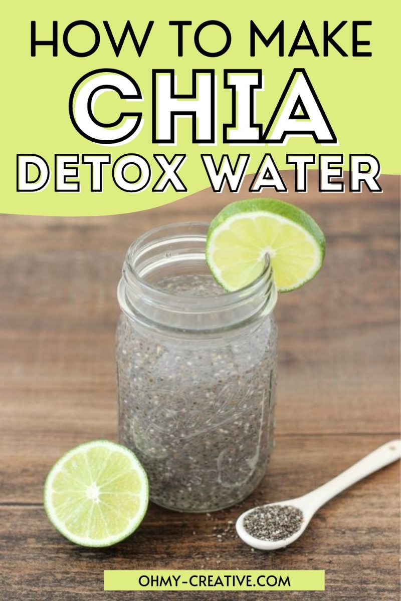 Mason jar with chia detox water with a slice of lime on the rim of the jar. A scoop of chia seeds and a lime lay on the wood table beside the jar.