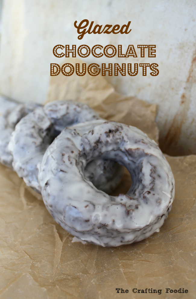 These Glazed Chocolate Cake Doughnuts have a rich chocolate flavor and are covered in a thick glaze giving them a crunchy coating with a soft interior! | The Crafting Foodie via OHMY-CREATIVE.COM