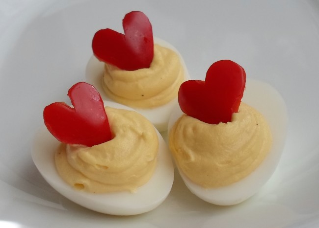 deviled eggs with red pepper hearts