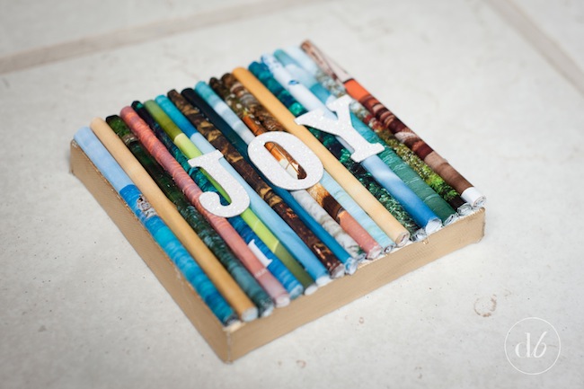 Don't discard old magazines. Repurpose them into a cool home decor accent like this Upcycle Magazine Art!  By Dwell Beautiful for OHMY-CREATIVE.COM