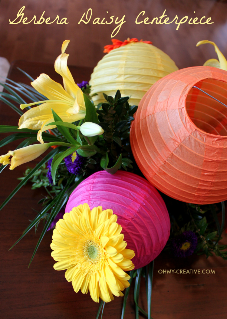 Gerbera daisies are one of my favorite flowers. The incredible vibrant blooms make them a perfect flower for so many occasions like this Gerbera Daisy Centerpiece! This gorgeous centerpiece is perfect for bridal showers, weddings and summer parties! I love the paper lanterns too! | OHMY-CREATIVE.COM