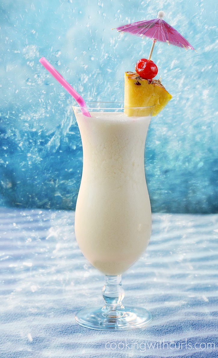 A sweet tropical cocktail made with rum pineapple juice and coconut cream cookingwithcurls.com