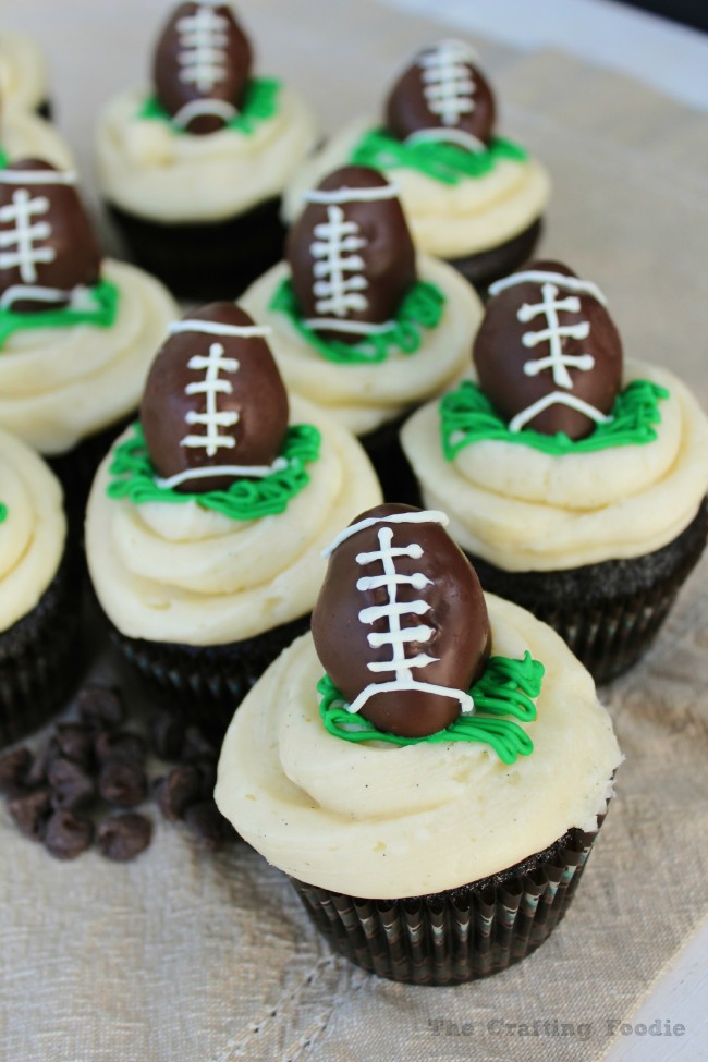 These Chocolate Cupcakes with Football Cake Pop Toppers start with a rich, moist chocolate cupcake, and they are covered with the fluffiest vanilla frosting. These football cake pops turn an ordinary cupcake into the perfect football themed treat.|The Crafting Foodie via OHMY-CREATIVE.COM