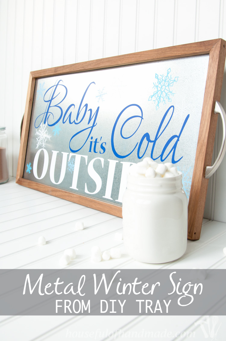 Baby It's Cold Outside is the perfect sign for a hot cocoa or coffee bar. Make this beautiful metal Winter Sign from DIY tray to add a little sparkle to it! | OHMY-CREATIVE.COM