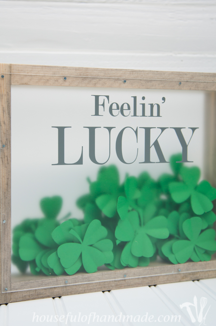 Make a beautiful shadow box full of clovers for a fun St. Patrick's Day shadow box decor idea. See if you can find the one 4 leaf clover in the bunch. | OhMy-Creative.com