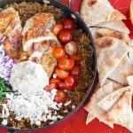 I absolutely love Mediterranean flavors like what's in this One Pot Greek Chicken and Rice recipe! Garden fresh tomatoes, humus and perfectly seasoned chicken topped with feta cheese will have the family asking for more Greek food! | OHMY-CREATIVE.COM