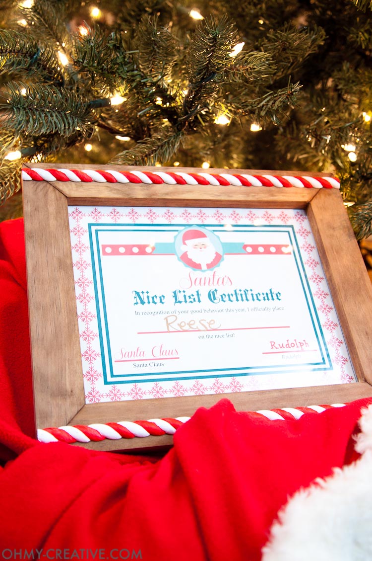 This is such a fun idea for a night before Christmas tradition! Let the kids know they made Santa's list with this easy DIY Christmas Photo Frame and a Nice List Certificate signed by Santa Claus. They will love going to bed knowing they will wake up to presents under the tree. | OHMY-CREATIVE.COM