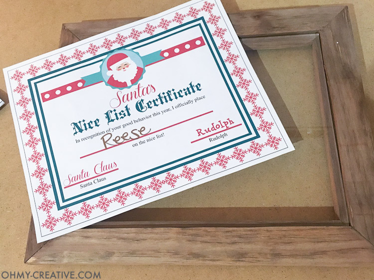 This is such a fun idea for a night before Christmas tradition! Let the kids know they made Santa's list with this easy DIY Christmas Photo Frame and a Nice List Certificate signed by Santa Claus. They will love going to bed knowing they will wake up to presents under the tree. | OHMY-CREATIVE.COM