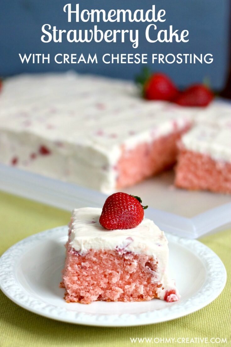 This Strawberry Cake With Whipped Cream Cheese Frosting is bursting with fresh strawberry flavor. A perfect dessert for any occasion spring or summer. OHMY-CREATIVE.COM | strawberry sheet cake | strawberry cake from scratch | homemade strawberry cake | fresh strawberry cake | whipped cream cheese frosting | spring dessert | summer dessert | dessert recipe | fresh strawberries | sheet cake recipe |