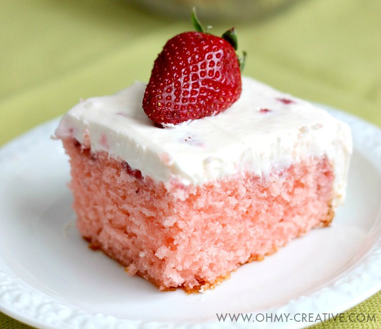 This Strawberry Cake With Whipped Cream Cheese Frosting is bursting with fresh strawberry flavor. A perfect dessert for any occasion spring or summer. OHMY-CREATIVE.COM | strawberry sheet cake | strawberry cake from scratch | homemade strawberry cake | fresh strawberry cake | whipped cream cheese frosting | spring dessert | summer dessert | dessert recipe | fresh strawberries | sheet cake recipe | 