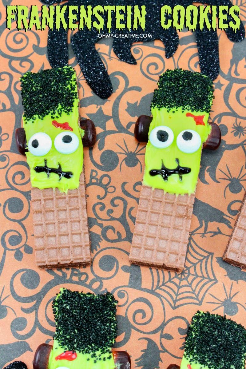 Frankenstein Cookies For Halloween made from store bought wafer cookies on a Halloween paper backdrop 