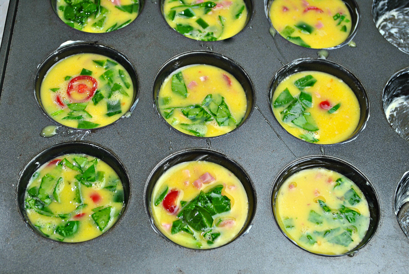 Raw Southwestern Healthy Egg Muffins mixture in muffin tins ready to be cooked