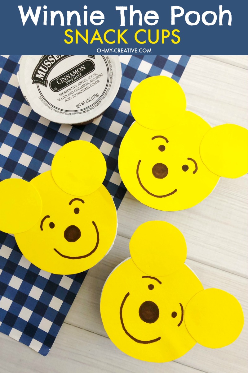 With a few supplies, these adorable Winnie The Pooh Food Snack Cups are easy to make. A sure hit with the kids for party food or party favors - healthy too! OHMY-CREATIVE.COM | Winnie the Pooh party favors | Winnie the Pooh party ideas |Winnie the Pooh party decorations | Winnie the Pooh baby shower | Winnie the Pooh 1st birthday | Snack Cups | applesauce cups #winniethepoohparty #winniethepooh #winniethepoohbabyshower #winniethepoohbirthdayparty #kidsparty