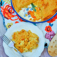 Round corn casserole with Jiffy baked with a single serving dished on a plate. Perfect for weeknight meals or a holiday side dish.
