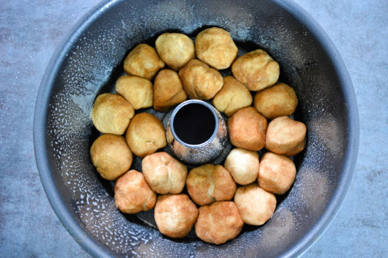 Rolled dough balls placed on the bottom of the baking pan