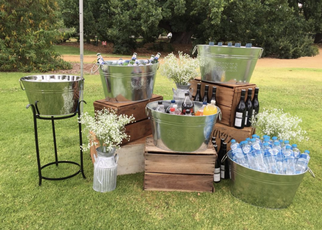 Backyard party drink station using wood crates and galvanized drink buckets