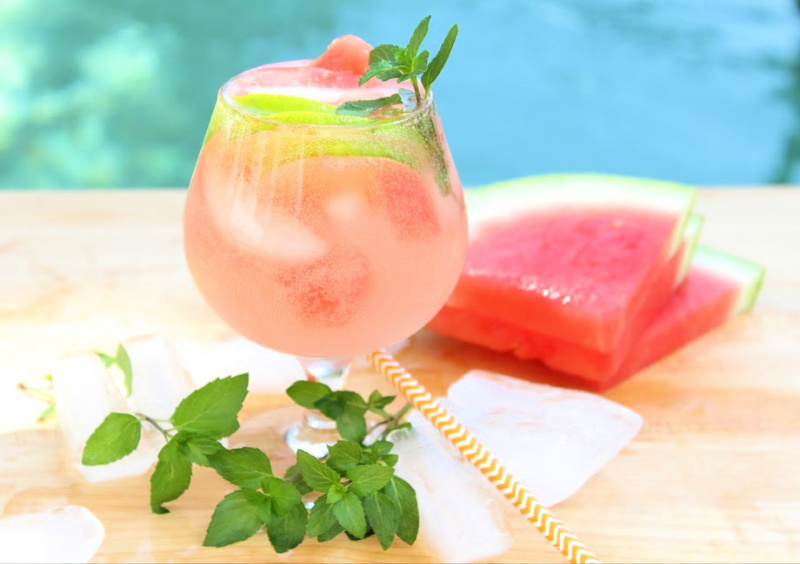 Watermelon cocktail with slice of lime garnish and fresh mint. 