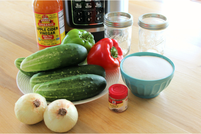 Fresh vegetables, canning jars and other supplies needed for making sweet pickle relish.