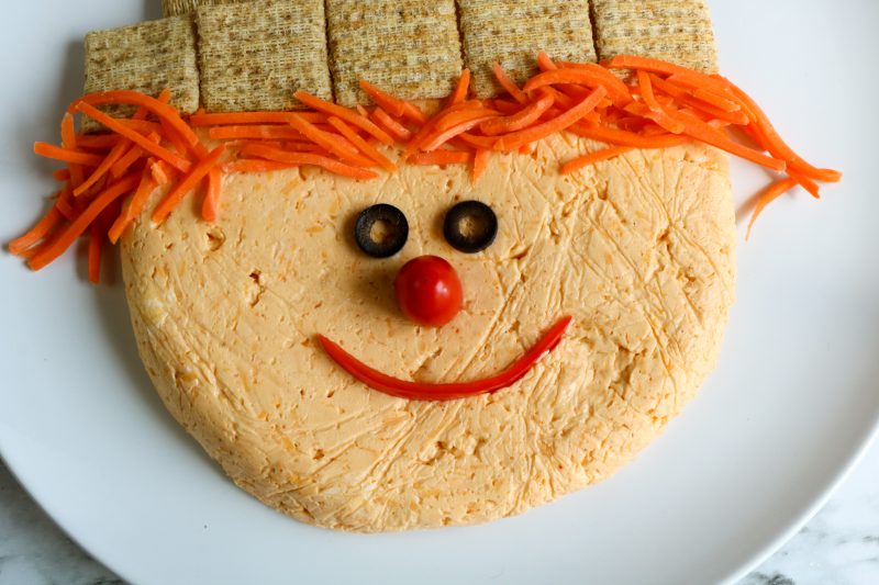 Scarecrow face is made of sliced olives for eyes, a tomato nose and a slice of red pepper for the mouth!