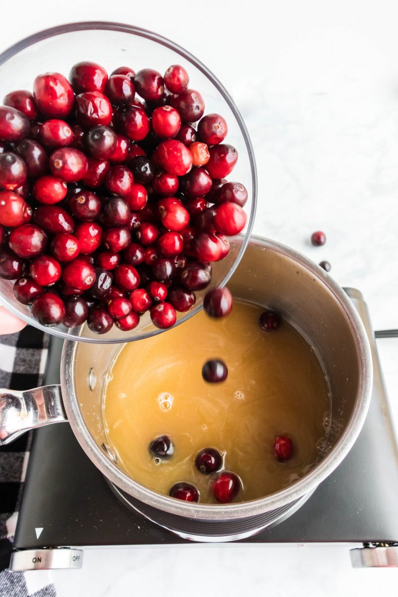 Slowly add cranberries into the post with orange juice.