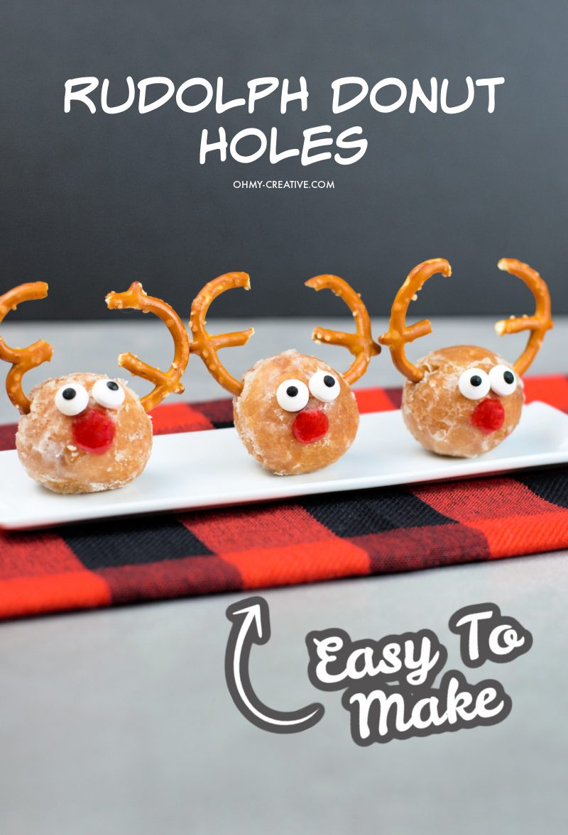 Three Rudolph Donut Holes sitting on a while dish placed on a buffalo plaid napkin.