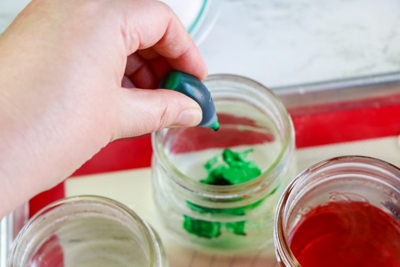 Add 6 to 10 drops of food coloring into each container and stir. You shouldn't need more food coloring than this.