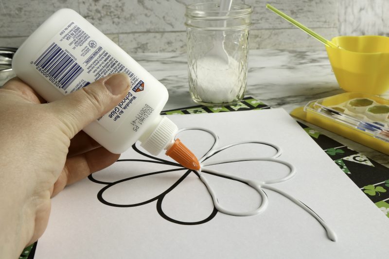 Use a bottle of glue to trace on top of the shamrock.