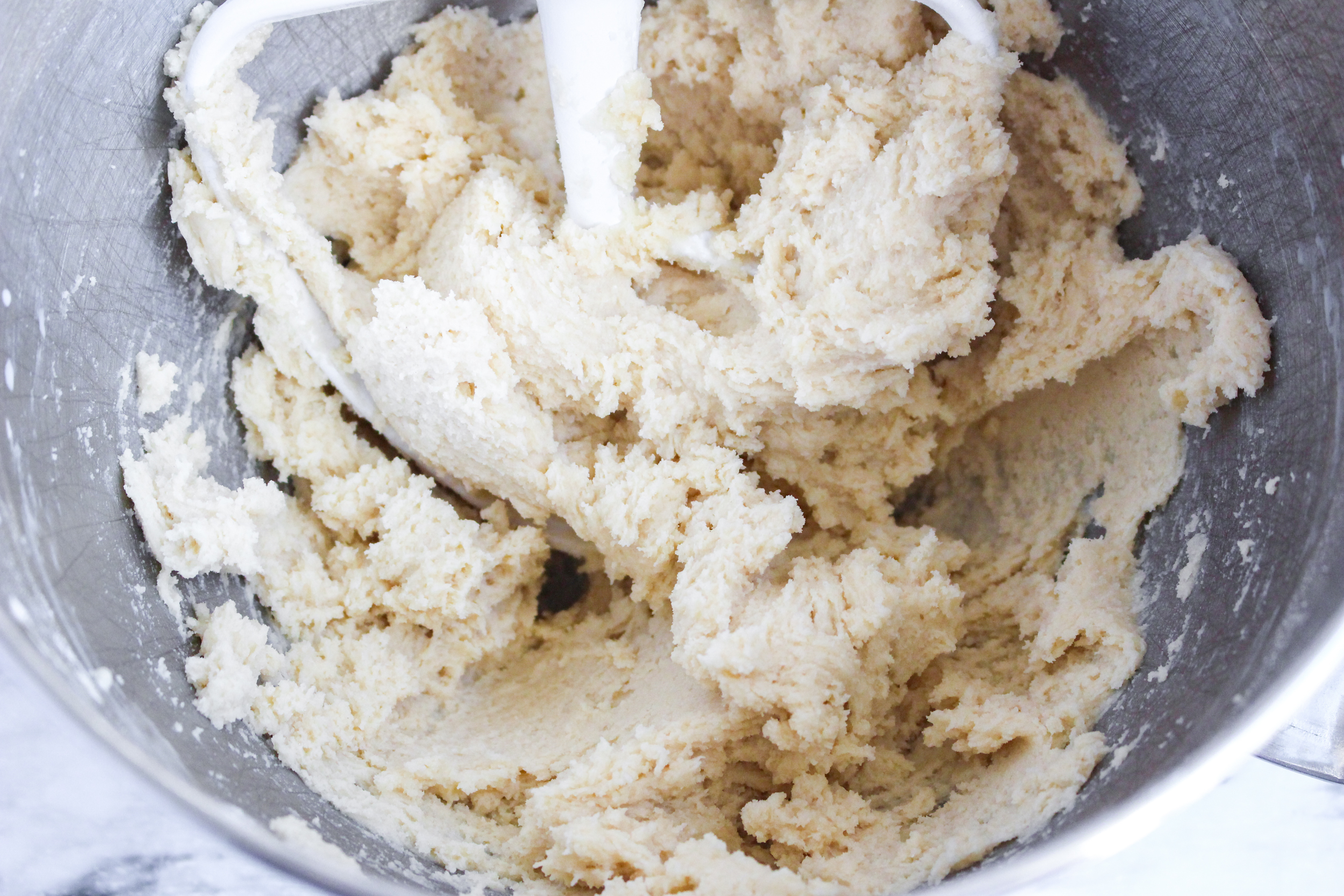 Blossom Cookie dough in a kitchen aid mixing bowl.