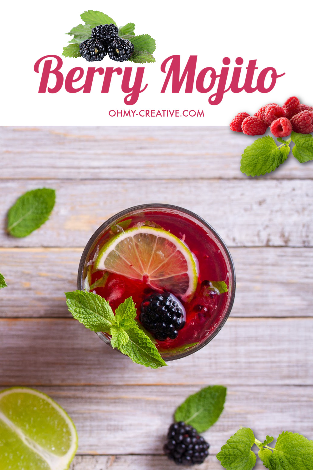A berry mojito on a gray wood background with sliced limes and mint.