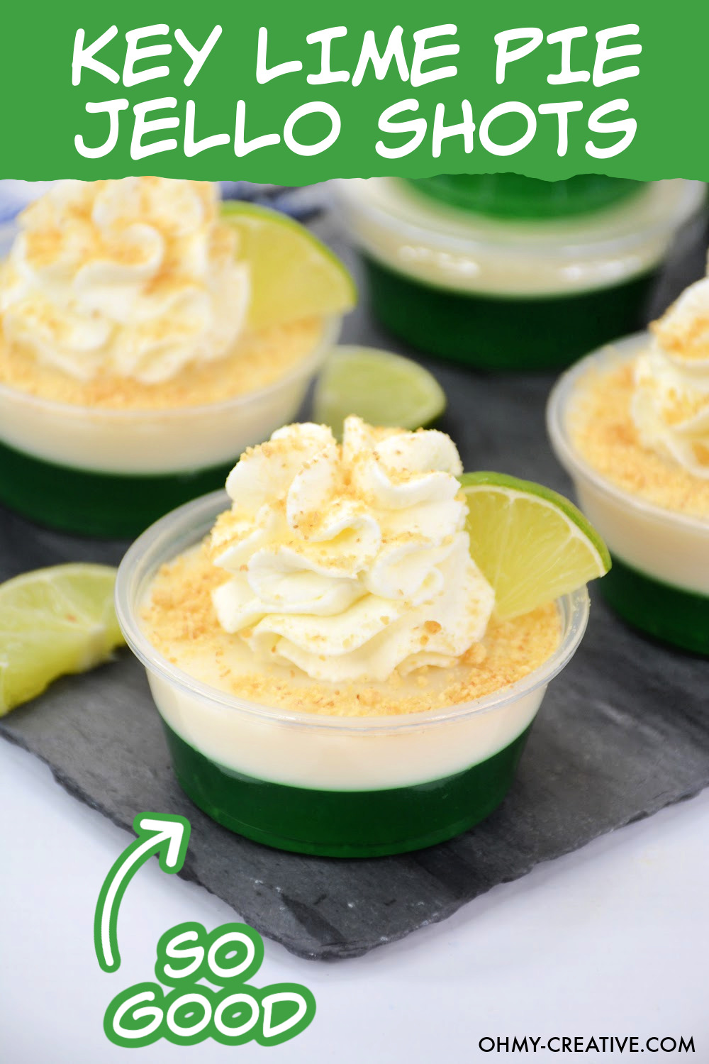These Key Lime Pie Jello Shots have a layer of lime Jell-o and a layer of creamy key lime pie filling topped with whipped cream and a sprinkle of gram cracker and a lime wedge.