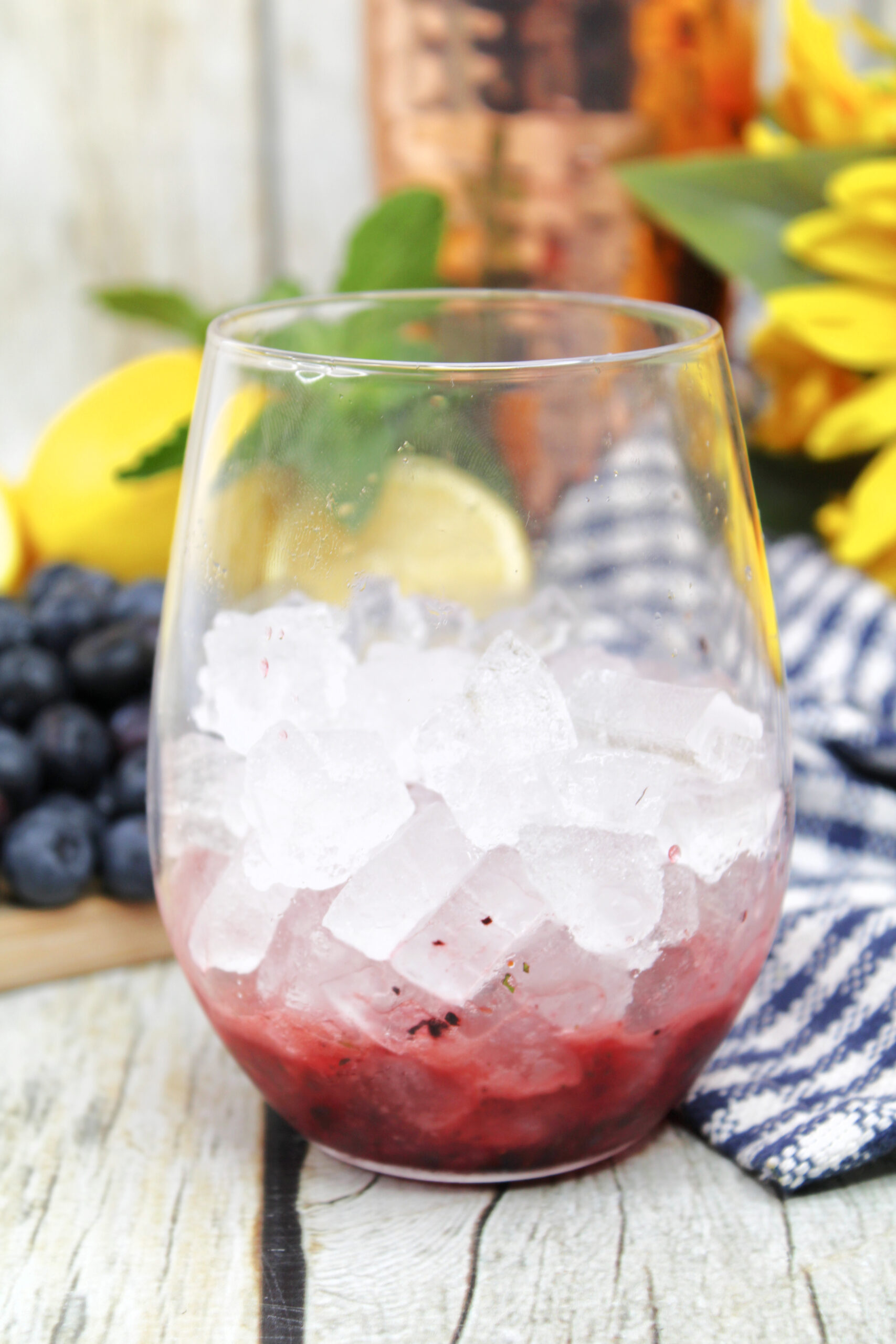 With the blueberry puree added to the bottom of the glass, then it is topped with ice!