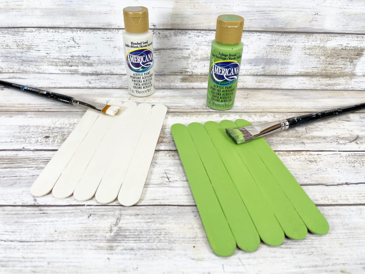 paint the popsicle sticks green and white for each Halloween craft.