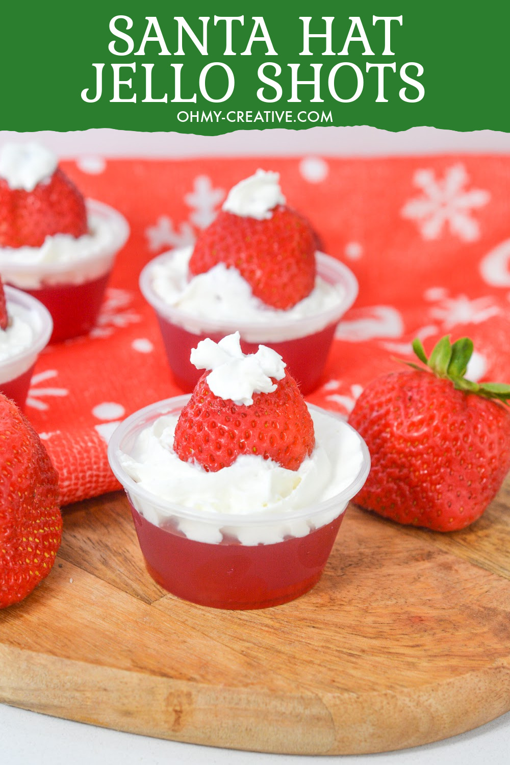 Whip up these Santa Hat Jello Shots using strawberry Jell-O, strawberries and whipped cream - a tasty strawberry jello shot recipe. 
