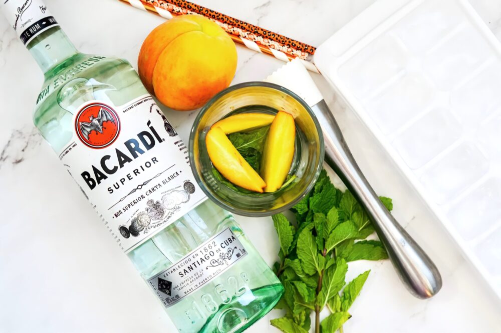 add fresh peaches and muddle with the mint.