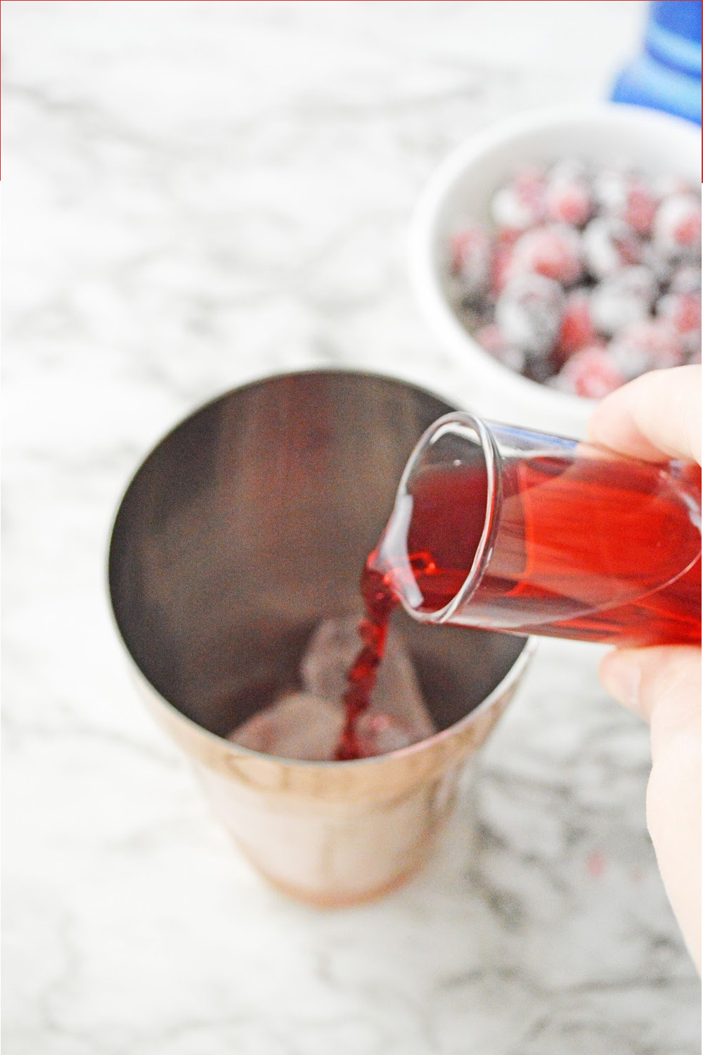 Add in cranberry juice to a martini shaker.