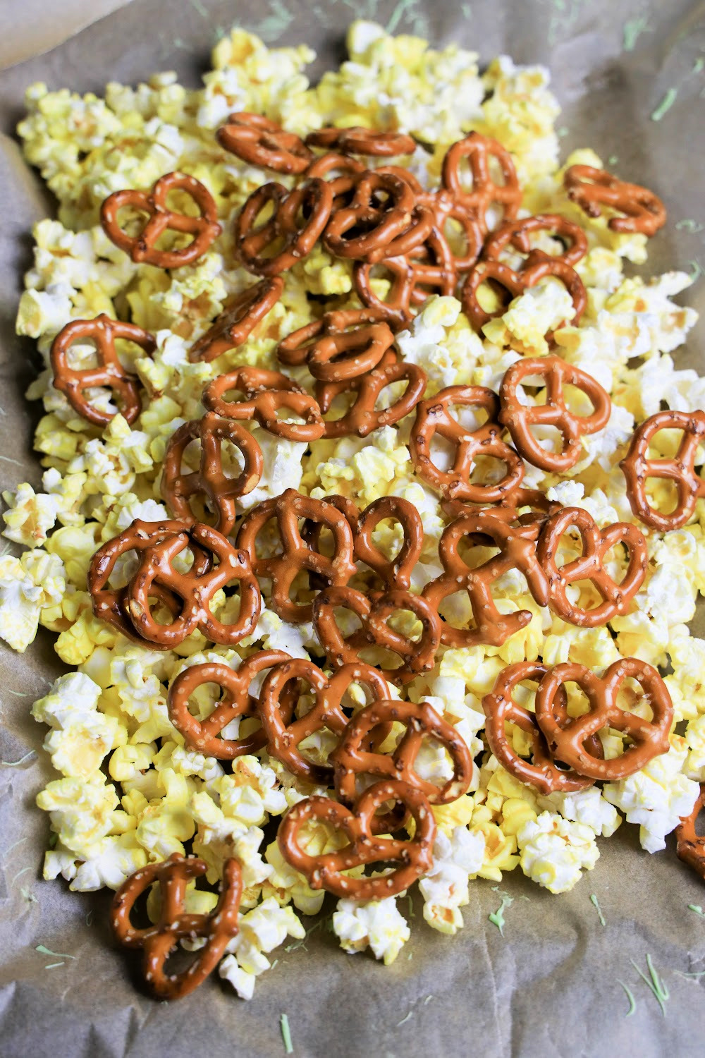 Next, layer some mini pretzels on top of the popcorn. You could use pretzel sticks instead. Or, add some flavored mini pretzels.