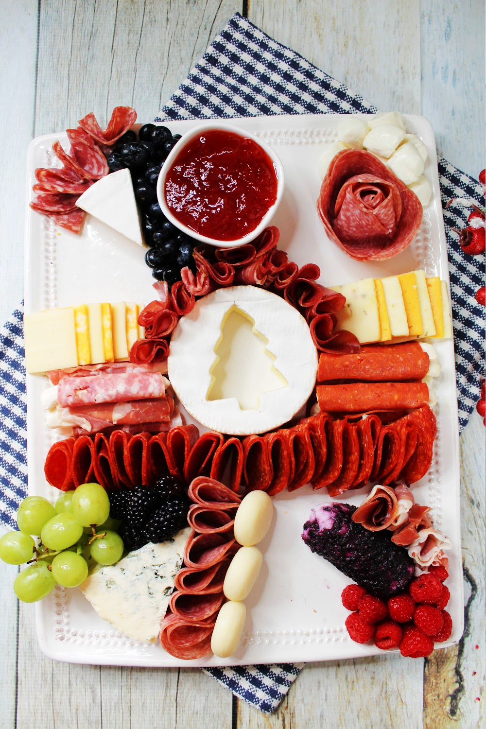Add fruits and jellies to the charcuterie board.