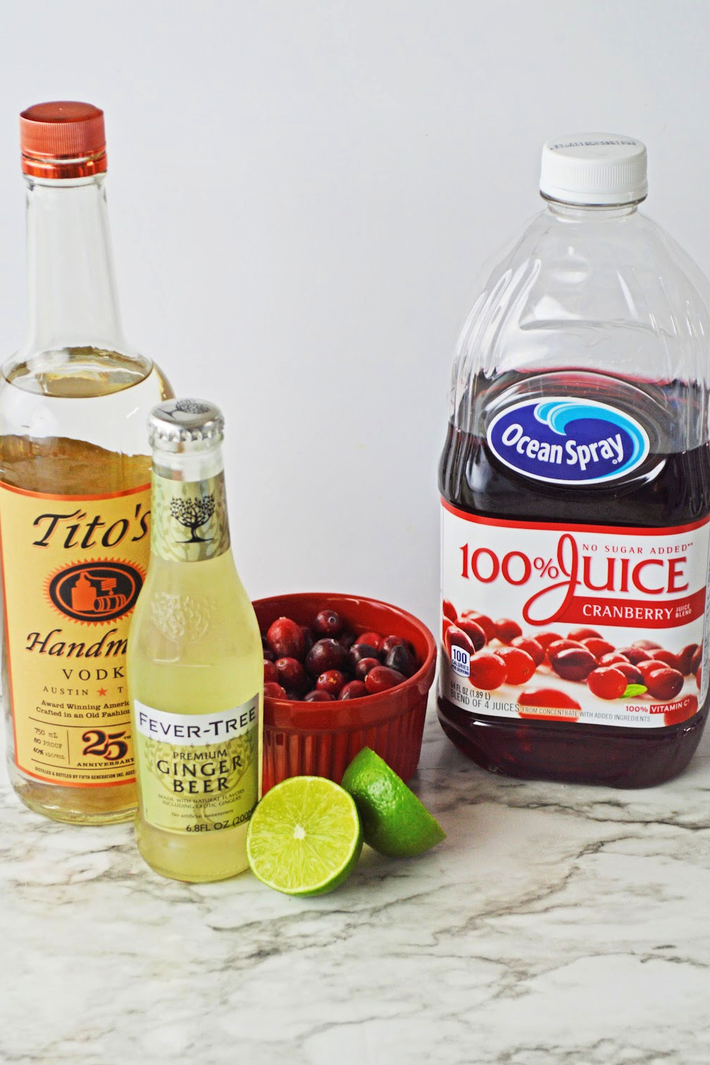 Bottles of ingredients to make a cranberry Moscow mule.