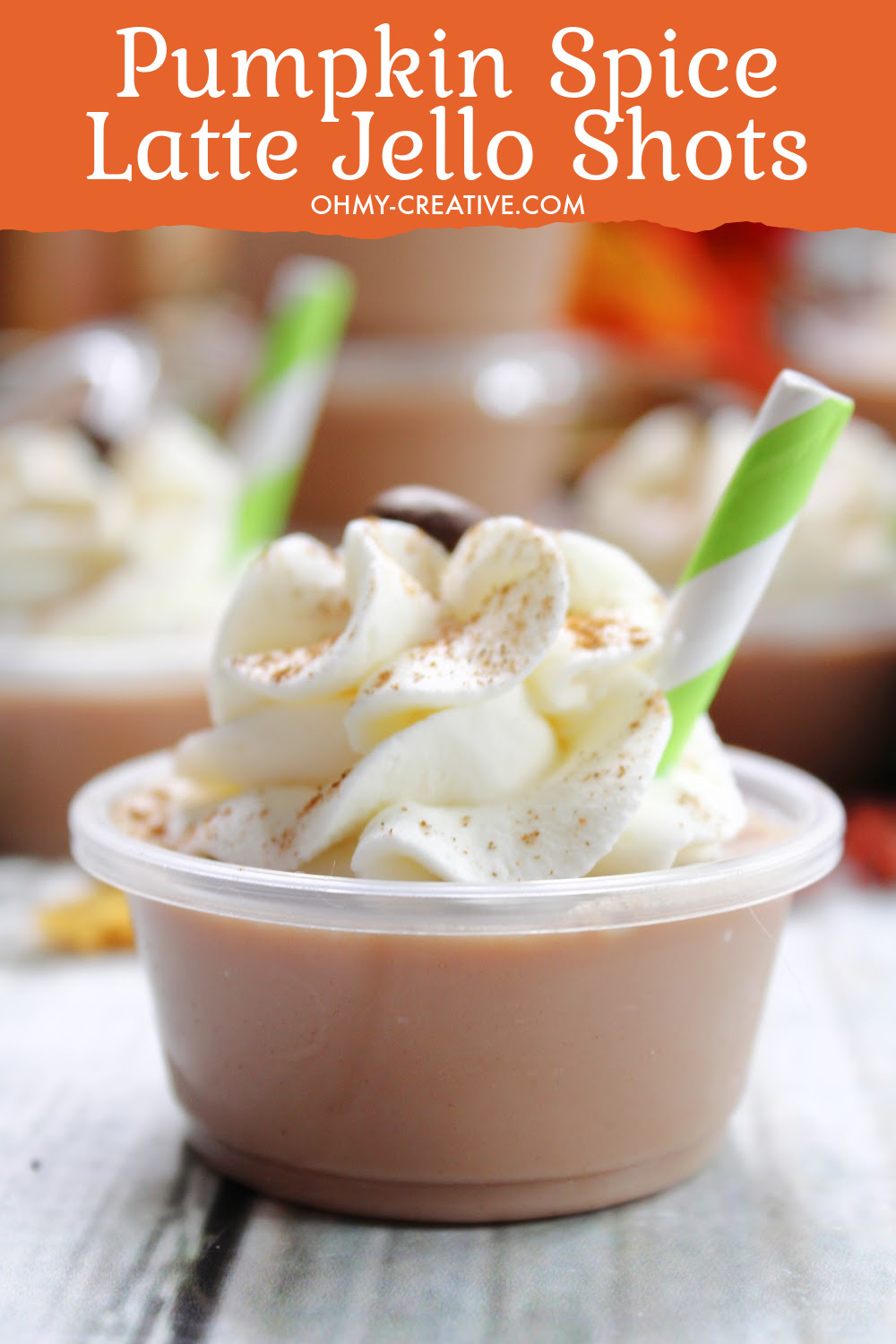 A close up view of a yummy pumpkin spice latte jello shots topped with whipped cream and dusted with cinnamon!