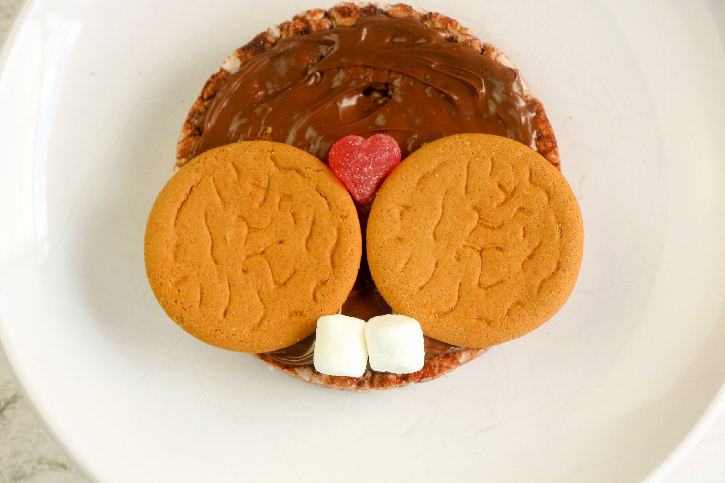 Add the heart candy as the nose and the marshmallows as the cute little buck teeth. 