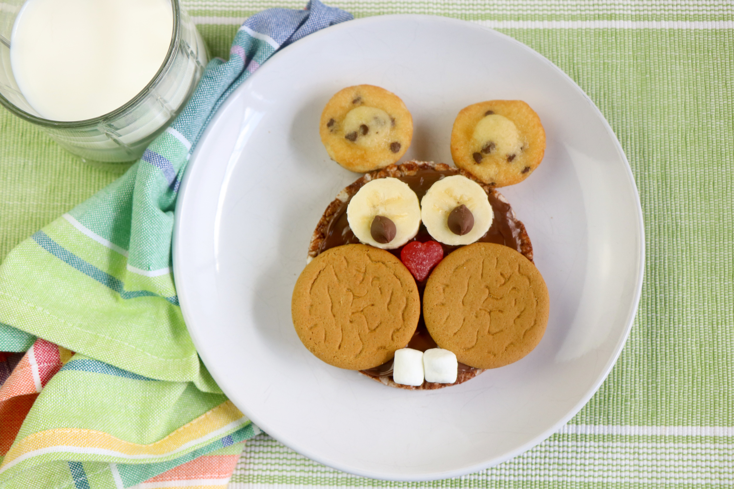 Add the bananas and chocolate chips for the two little eyes. Then, just place the mini muffins on top as the ears! EASY! 