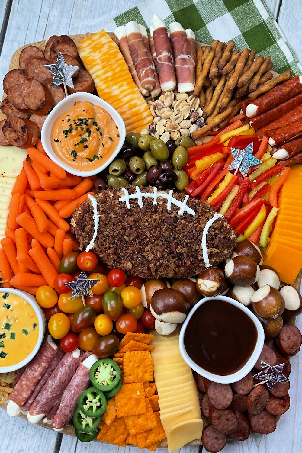 This game-day football charcuterie board includes a football shaped cheese ball and plenty of meats, cheeses and veggies.