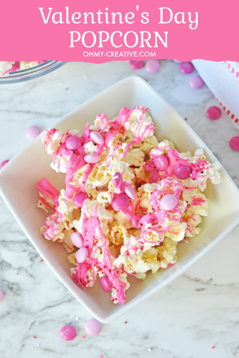 Valentines Popcorn with white and pink candy melts drizzled on top with pink M&Ms.